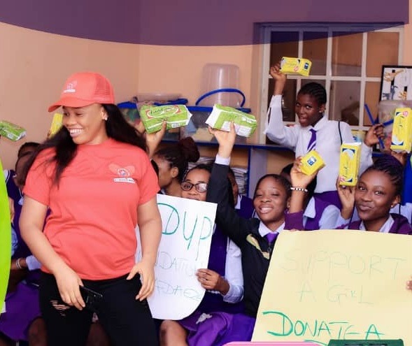 Volunteer sharing sanitary products with girls